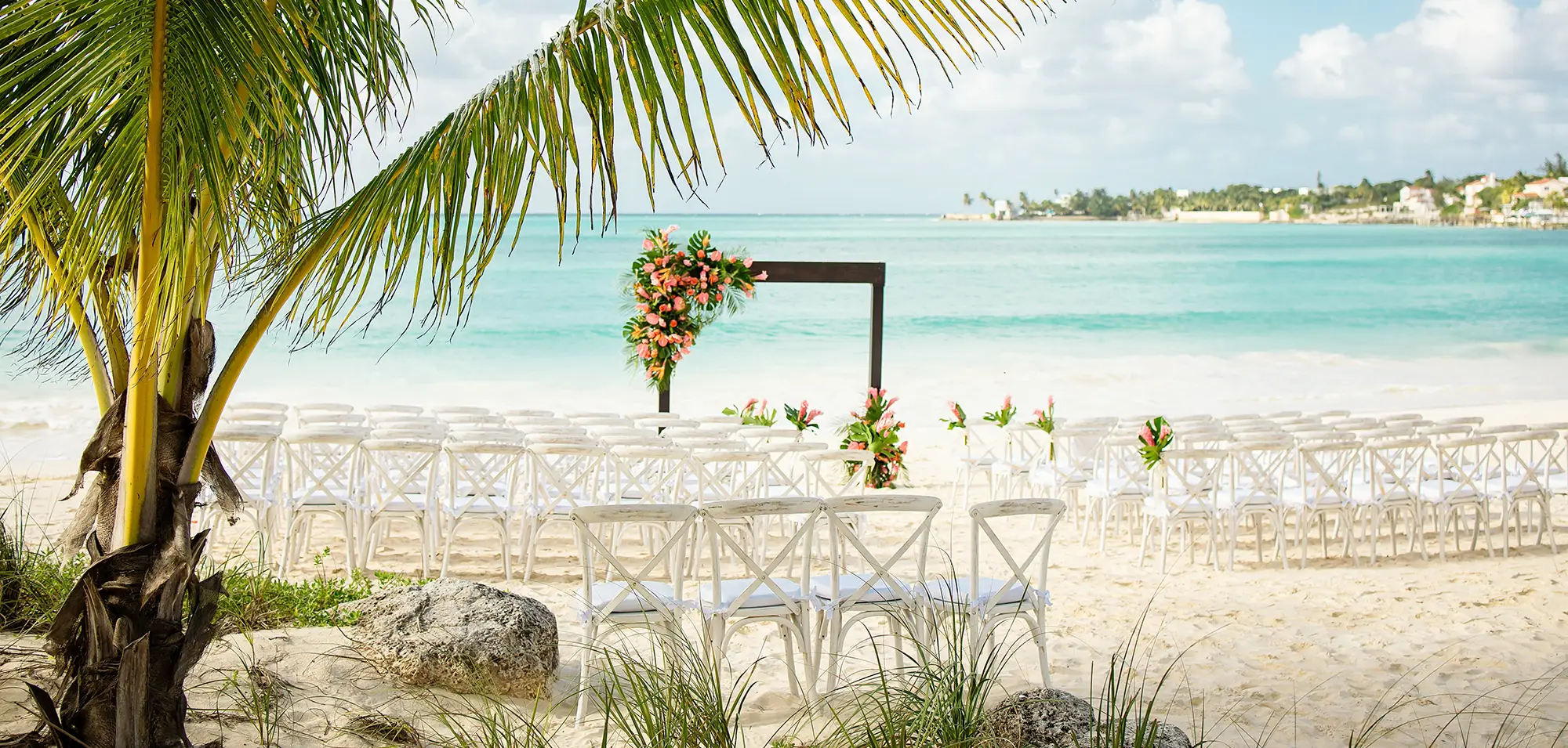 A beachfront ceremony at golden hour in the Bahamas