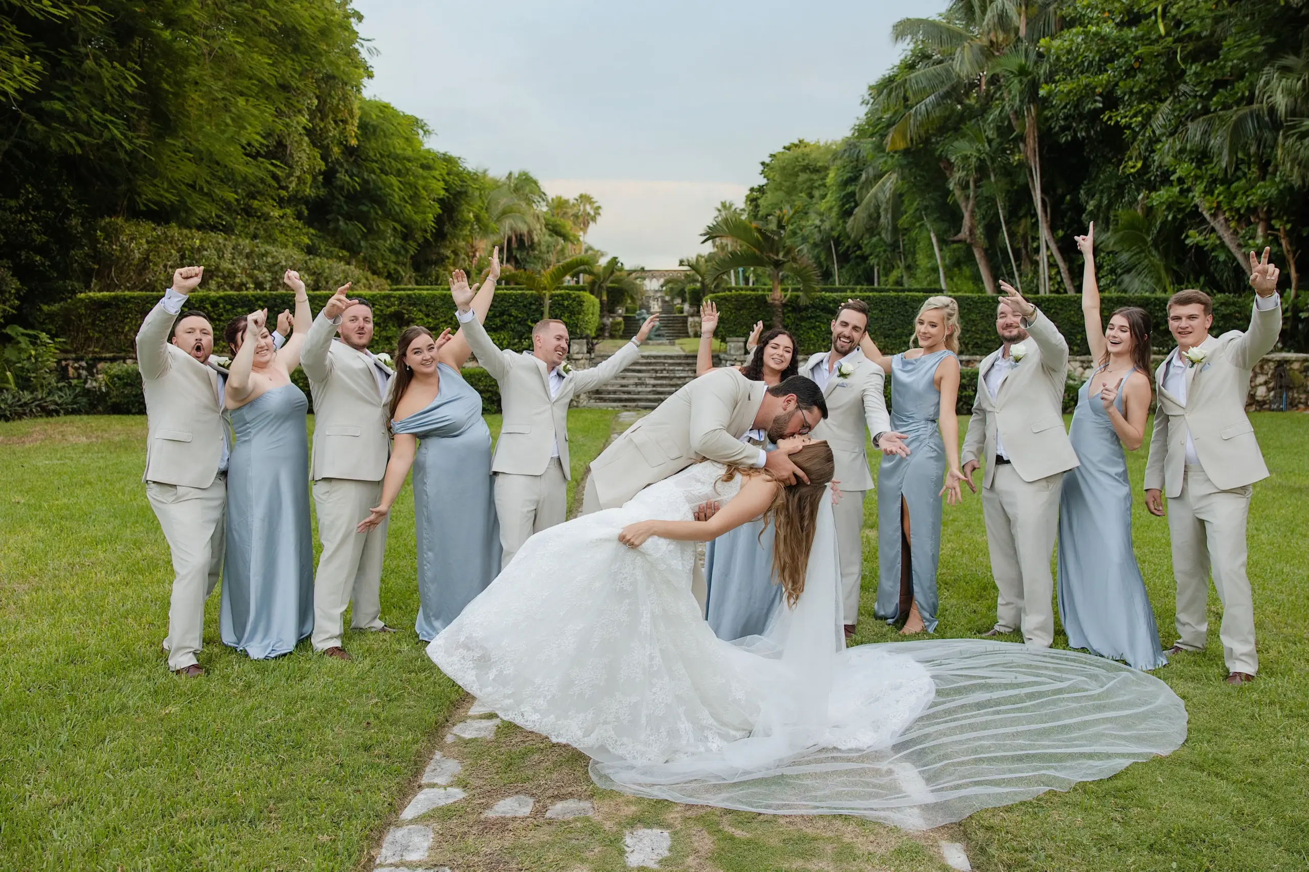 A Bahamas Wedding Couple sharing a kiss and taking a photo with their grooms and bridesmaids