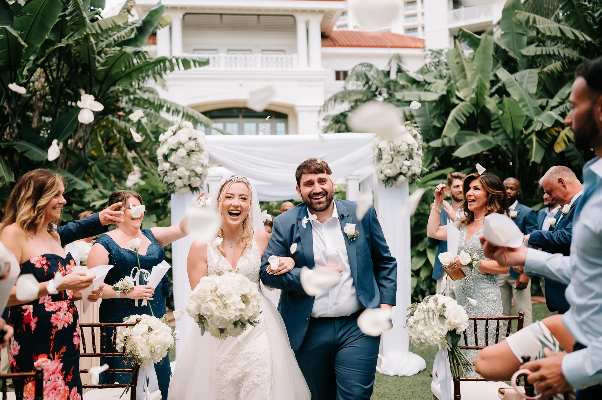 A Bahamas wedding couple walking down the aisle smiling